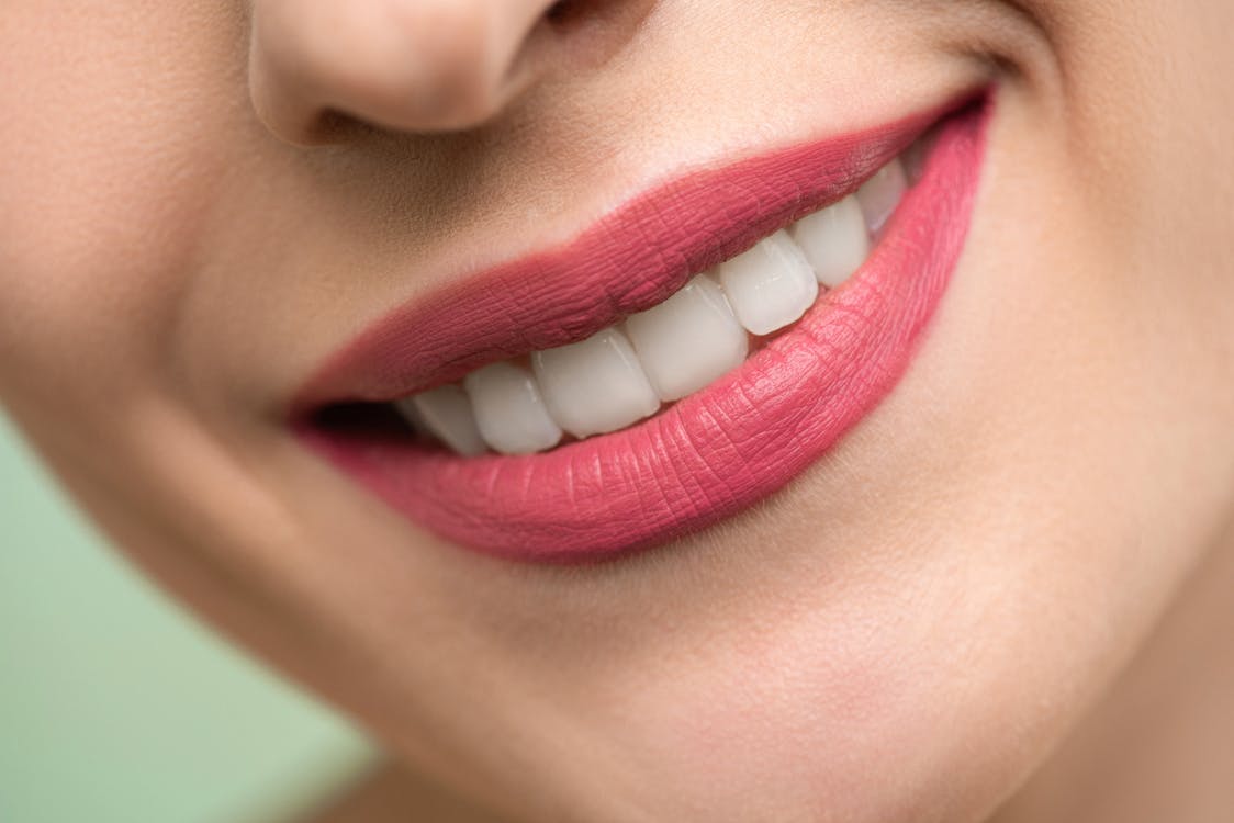 Woman with a healthy smile — the visible result of a balanced oral microbiome